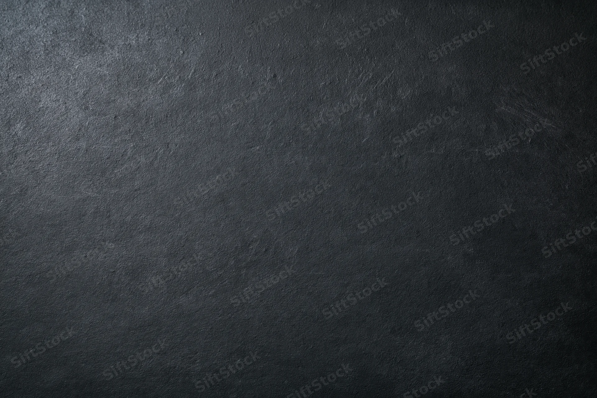 Close-up of dark charcoal textured surface filling the frame