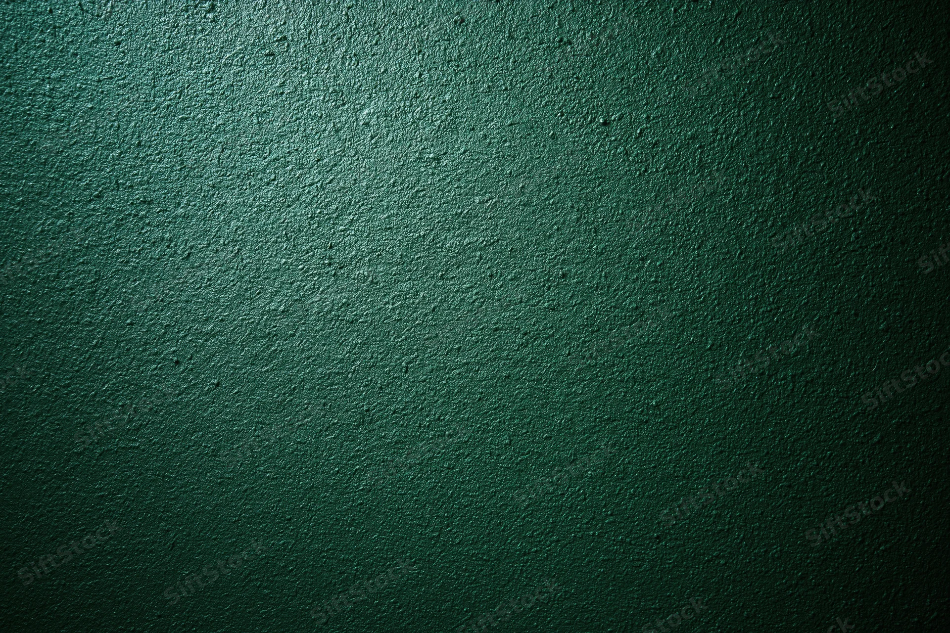 Close-up of deep forest green textured wall surface with rough matte finish and subtle gradient lighting