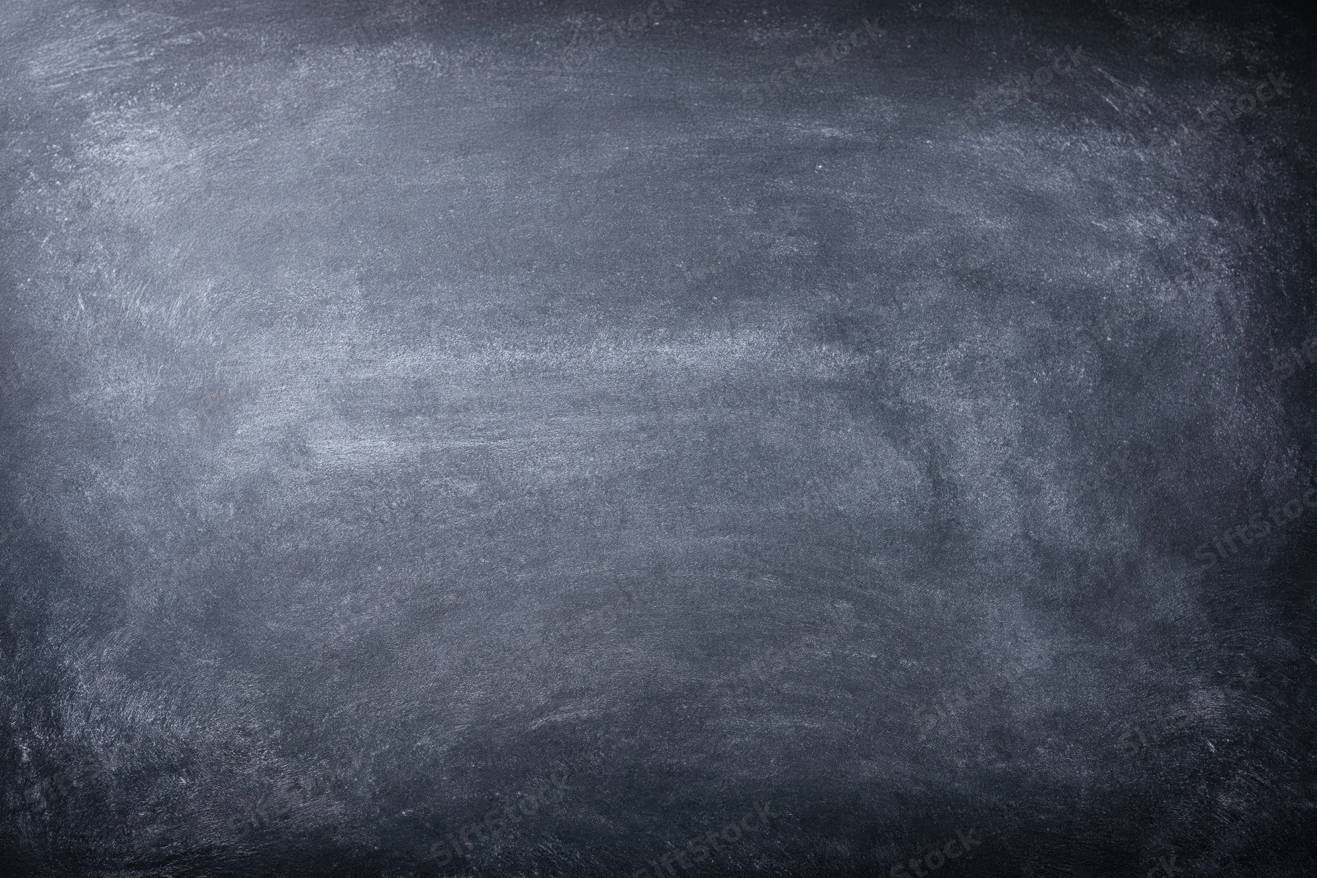 Close-up of a worn chalkboard surface with smudged residue and no writing