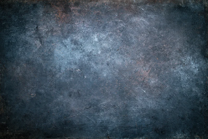 Close-up of a worn painted metal surface with rust and scratches