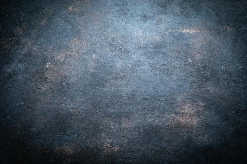 Close-up of a worn painted metal surface with grunge texture and blue-gray tones