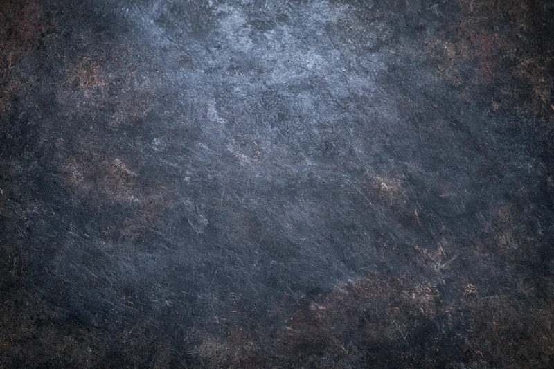 Close-up of a worn painted metal surface with rust and scratches