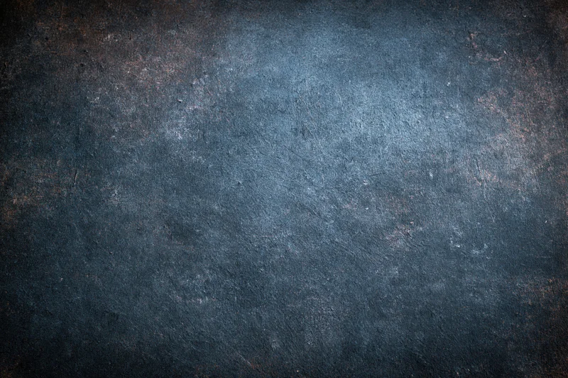 Close-up of a worn painted metal surface with rust and texture