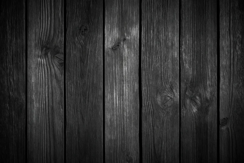 Dark weathered wooden planks arranged vertically as a textured surface