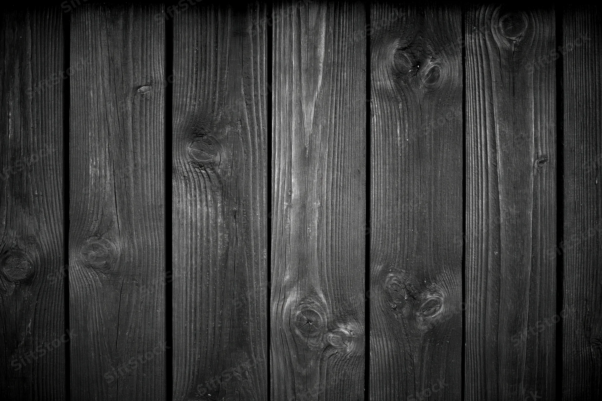 Dark weathered wooden planks arranged vertically as a textured surface