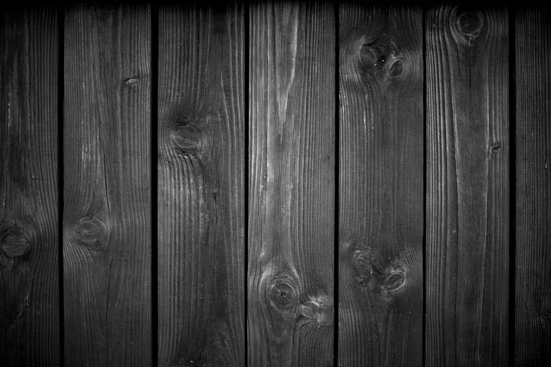 Dark weathered wooden planks arranged vertically as a textured surface