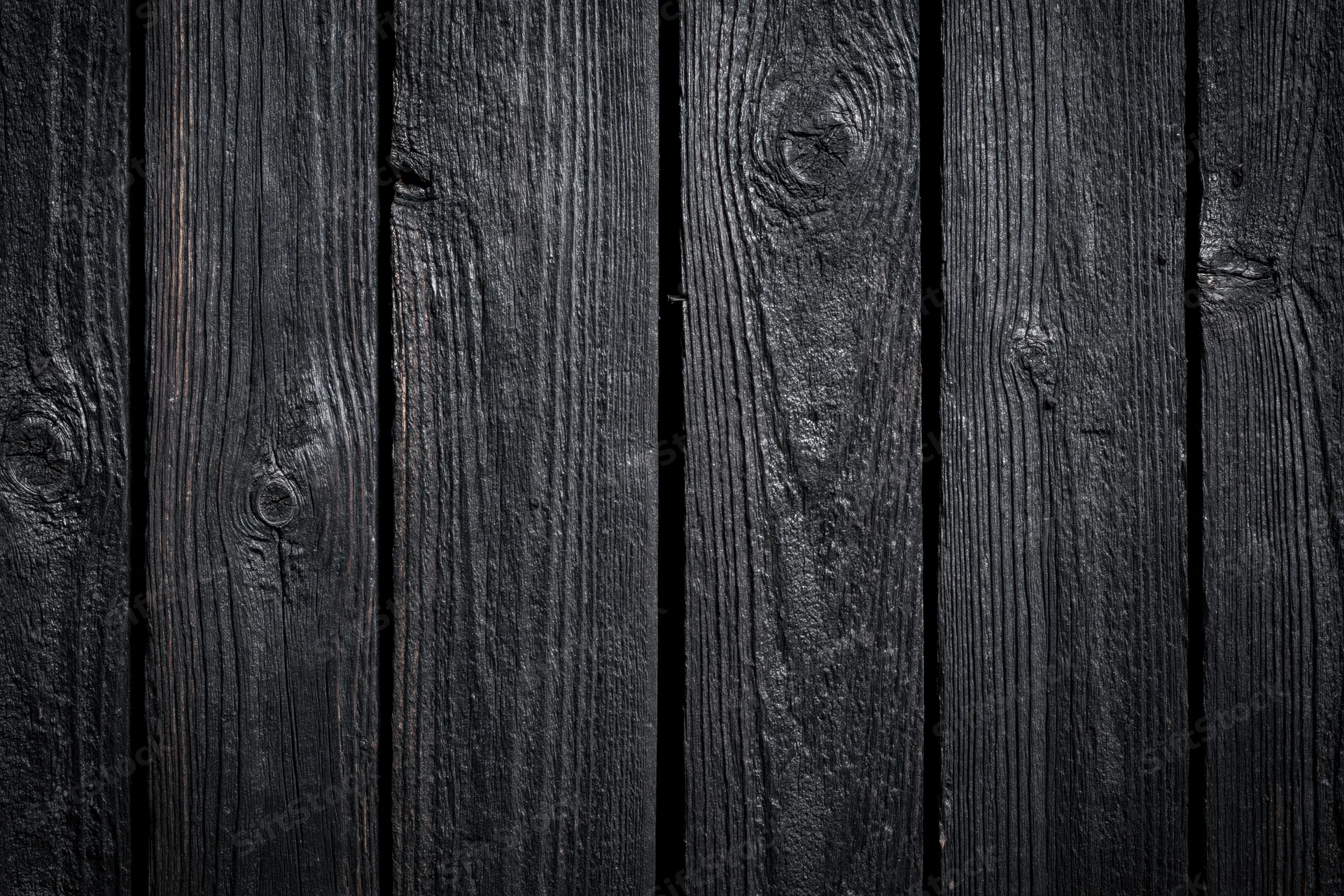 Dark weathered wooden planks arranged vertically as a textured surface