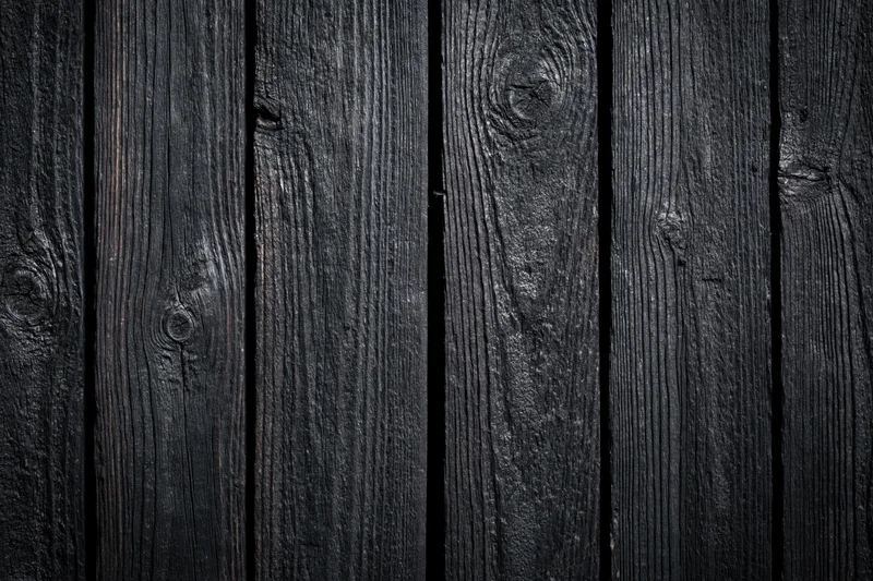 Dark weathered wooden planks arranged vertically as a textured surface