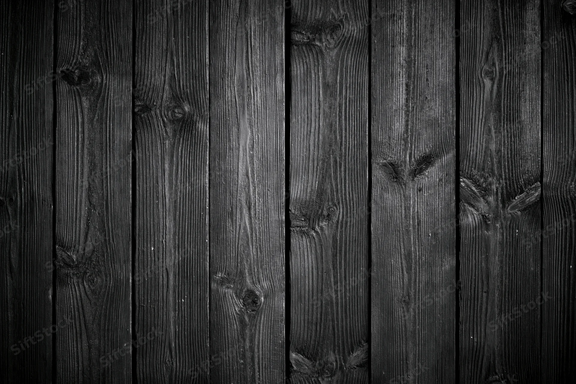Dark weathered wooden planks arranged vertically as a textured surface