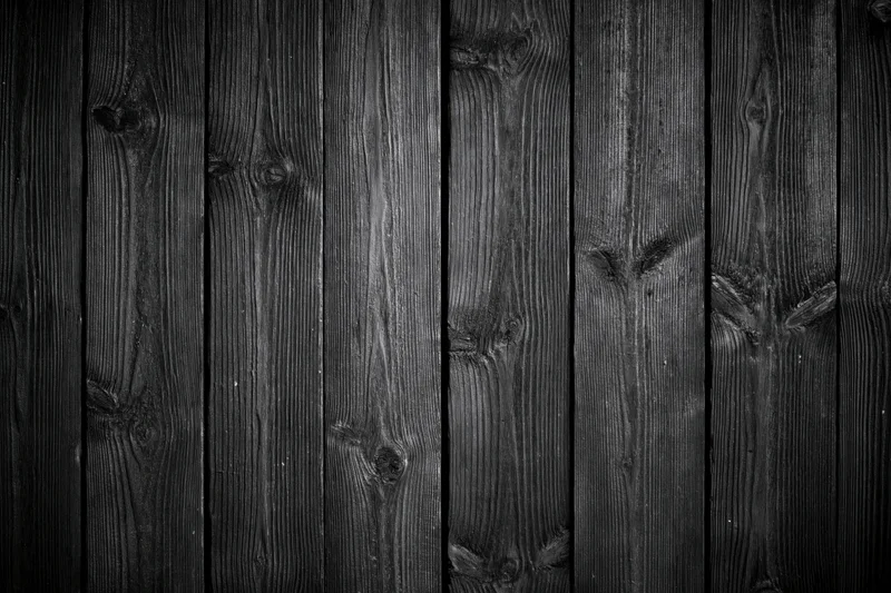 Dark weathered wooden planks arranged vertically as a textured surface