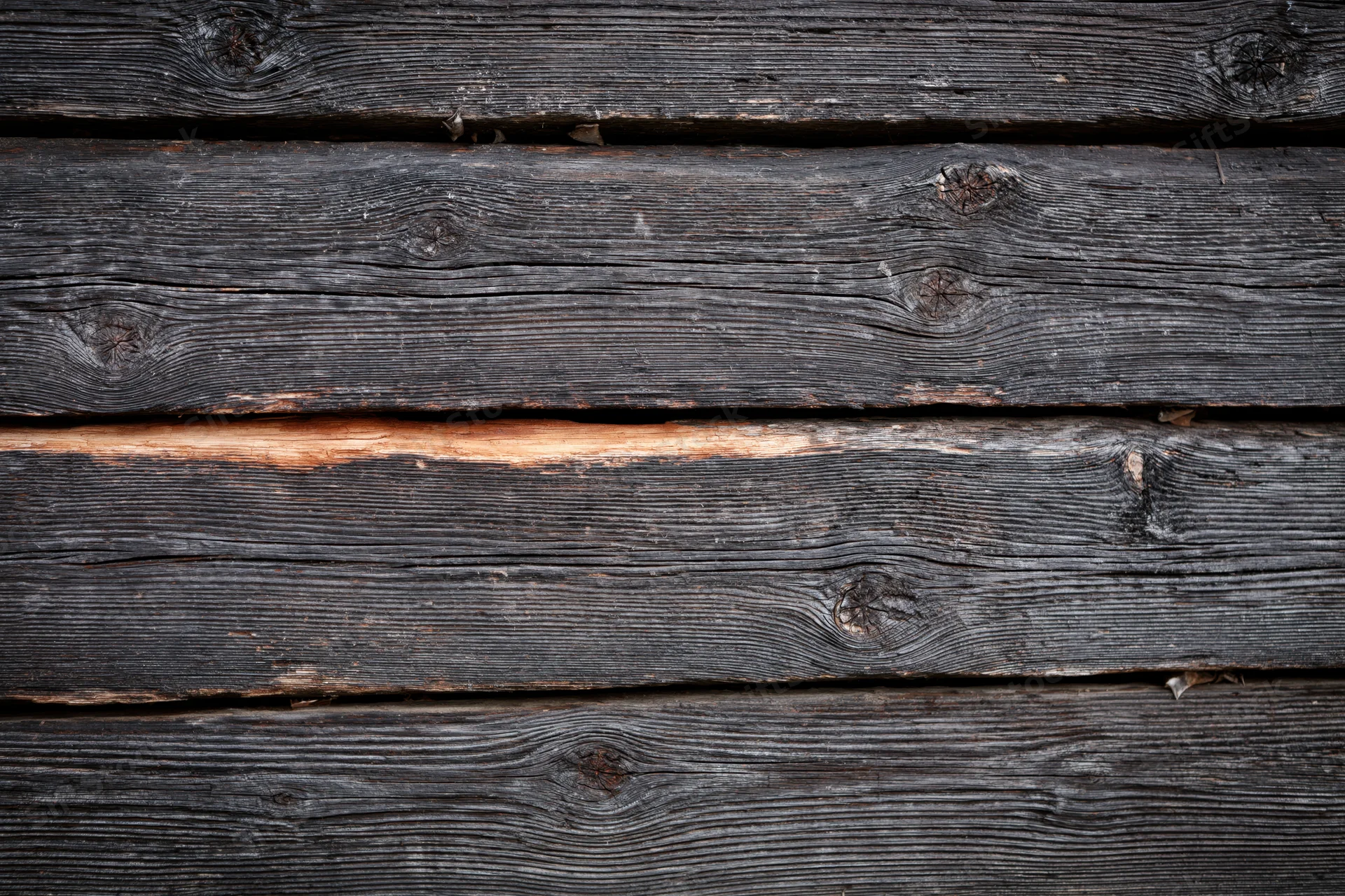 Close-up of weathered horizontal wooden planks forming a textured surface