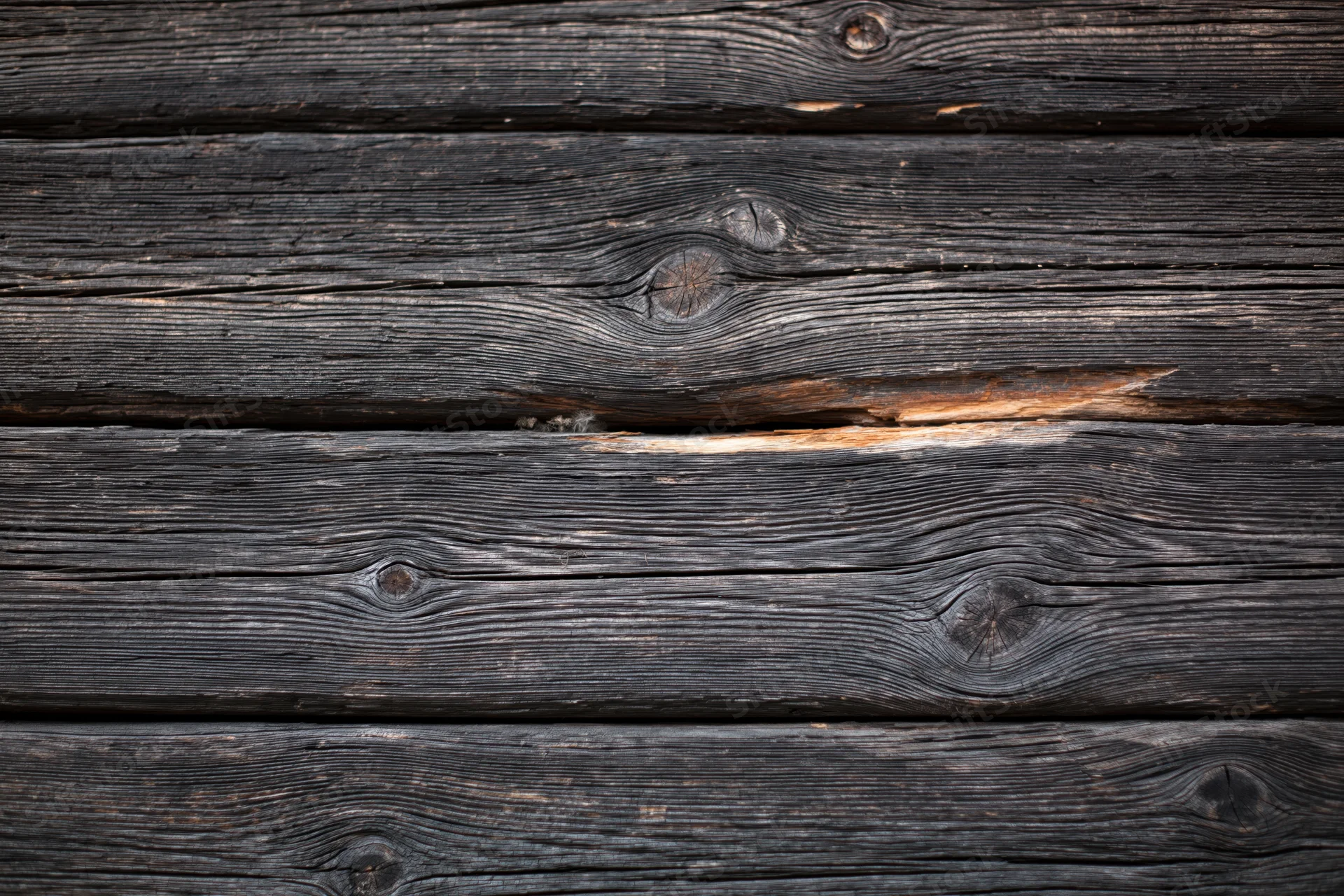 Horizontal weathered wooden planks forming a dark textured surface