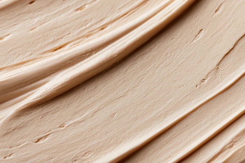 Close-up of smooth beige cosmetic cream texture