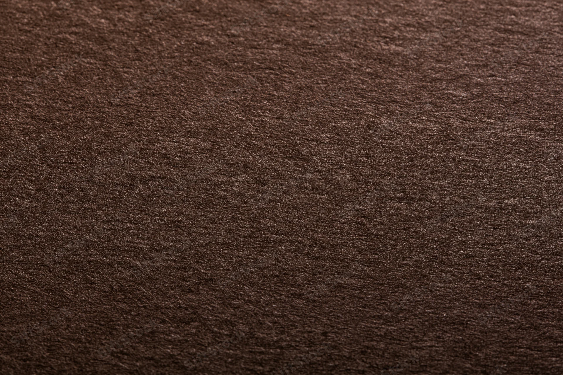 Close-up of dark chocolate brown textured paper surface