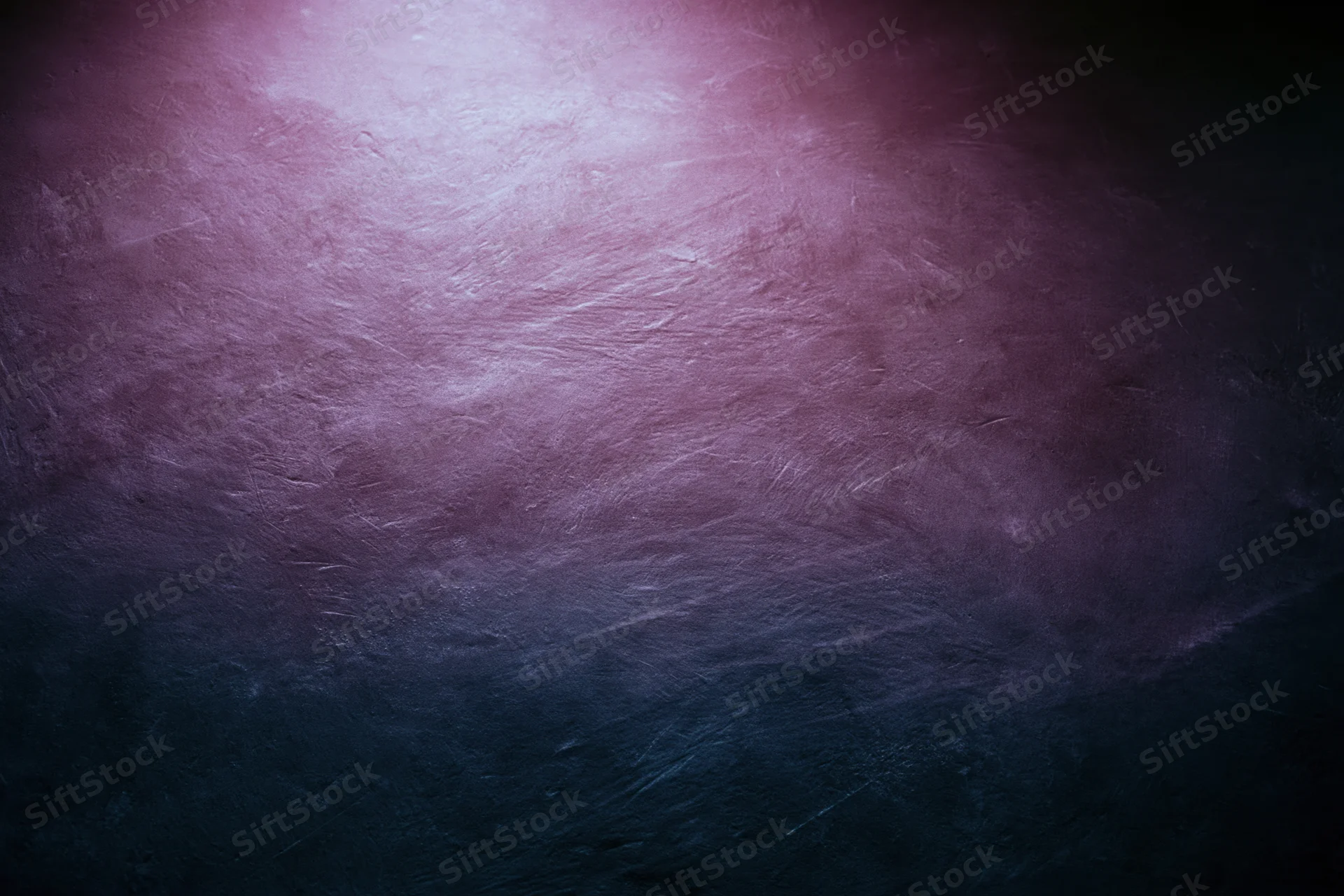Close-up of a worn concrete wall surface with purple and blue gradient lighting