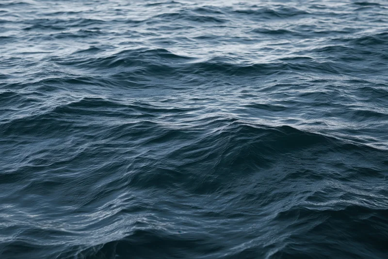 Close-up view of dark blue ocean waves rolling across the open sea surface