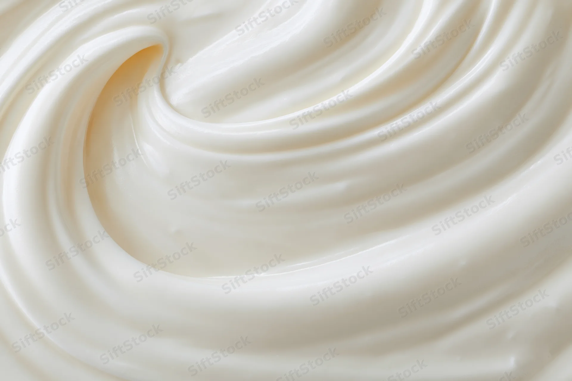 Close-up of thick creamy white yogurt swirl with smooth texture