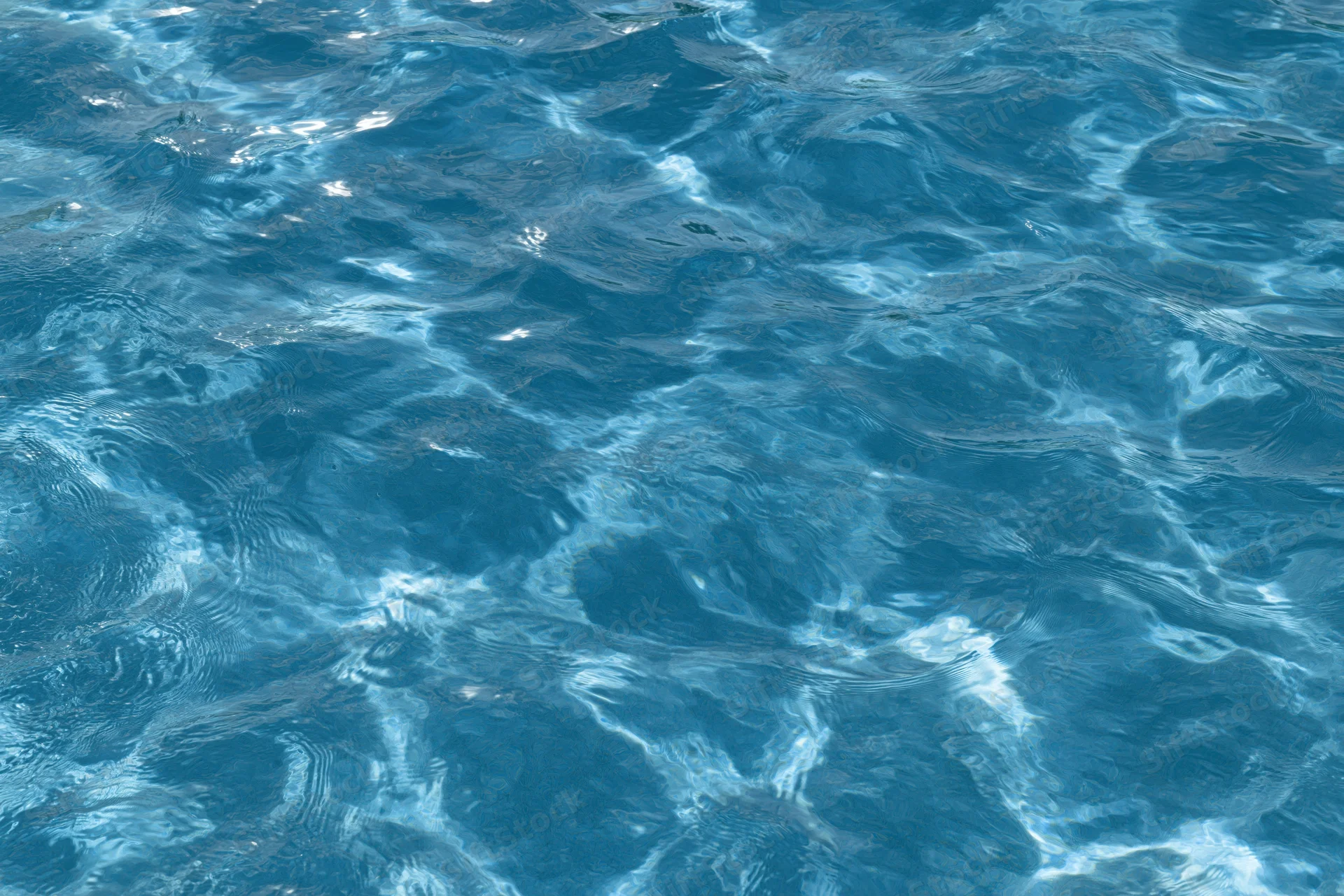 Rippling surface of pool water with light reflections and ripples