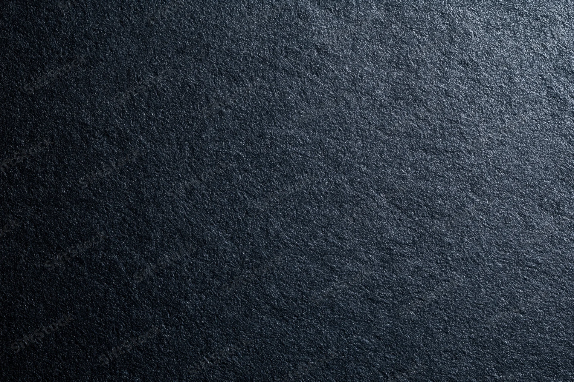 Dark charcoal matte surface filling the frame with rough texture