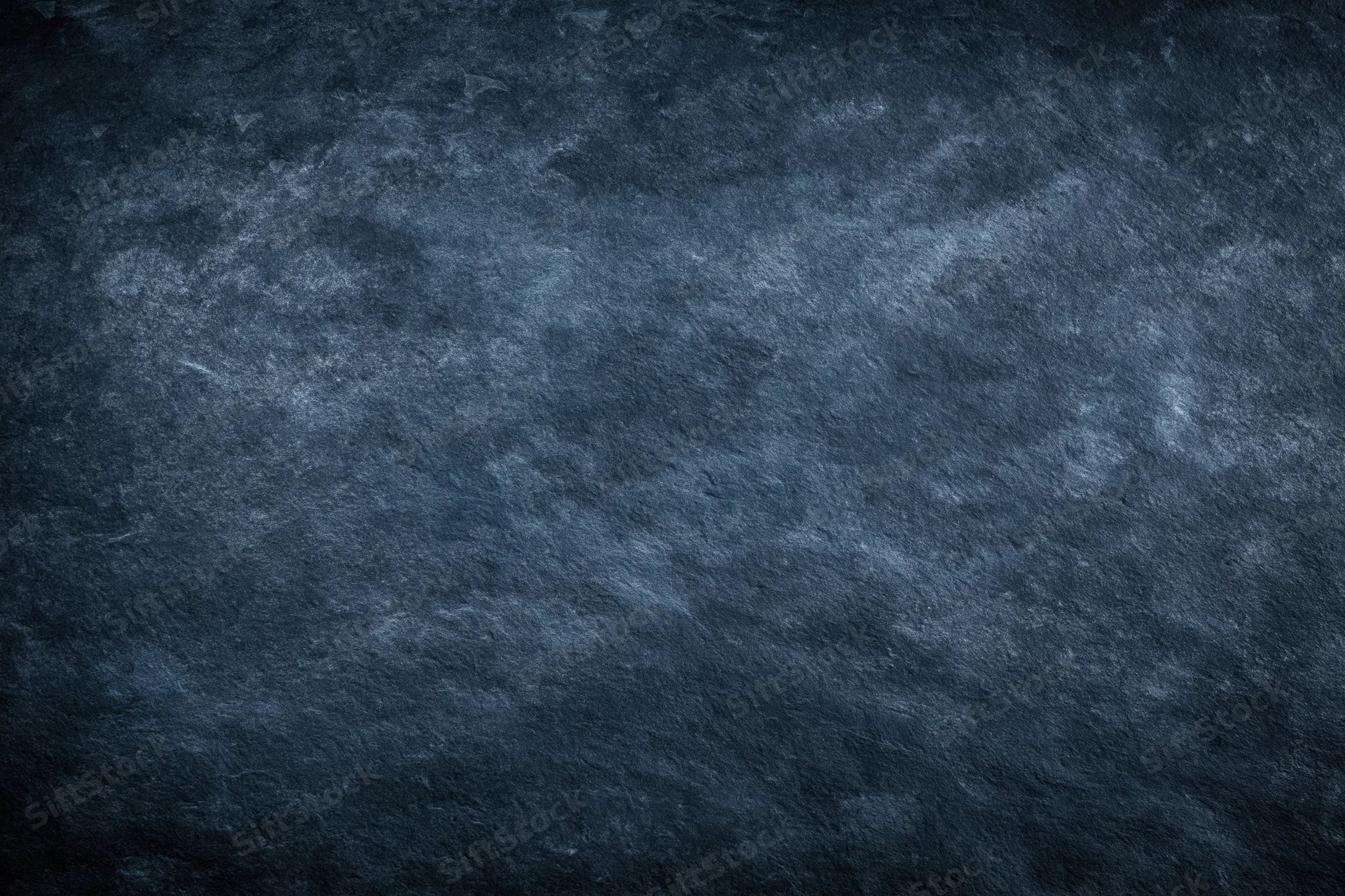 Dark mottled slate surface texture filling the frame