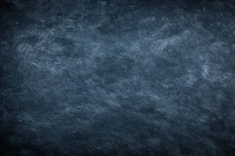 Dark mottled slate surface texture filling the frame
