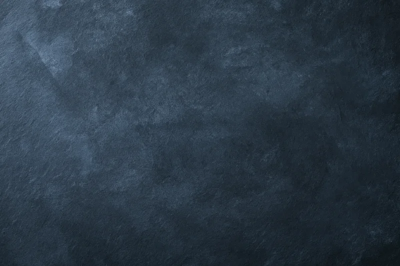 Dark mottled slate surface texture filling the frame