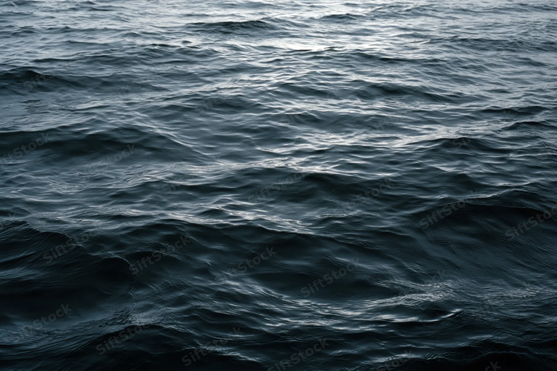 Dark rippling ocean surface viewed from above filling the frame