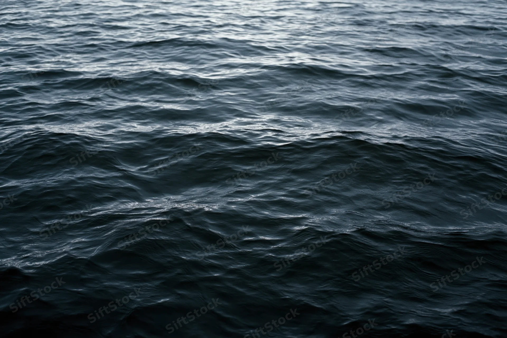 Dark rippling ocean surface viewed from above filling the frame