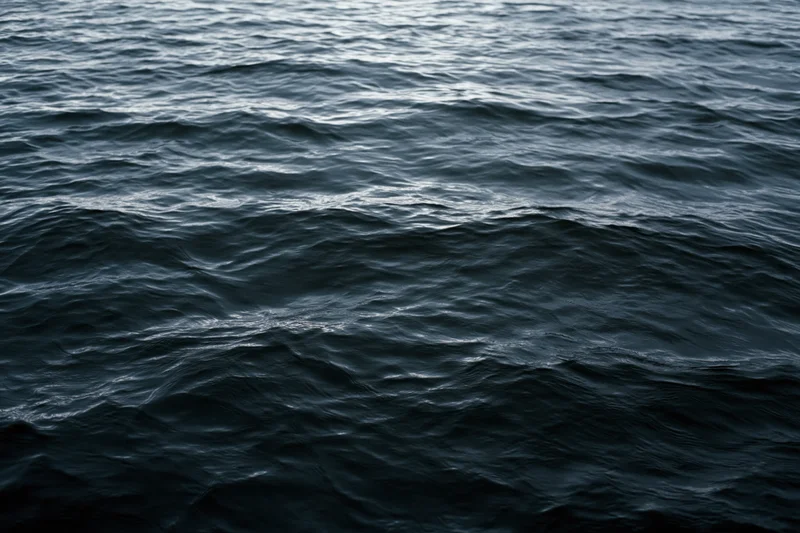 Dark rippling ocean surface viewed from above filling the frame