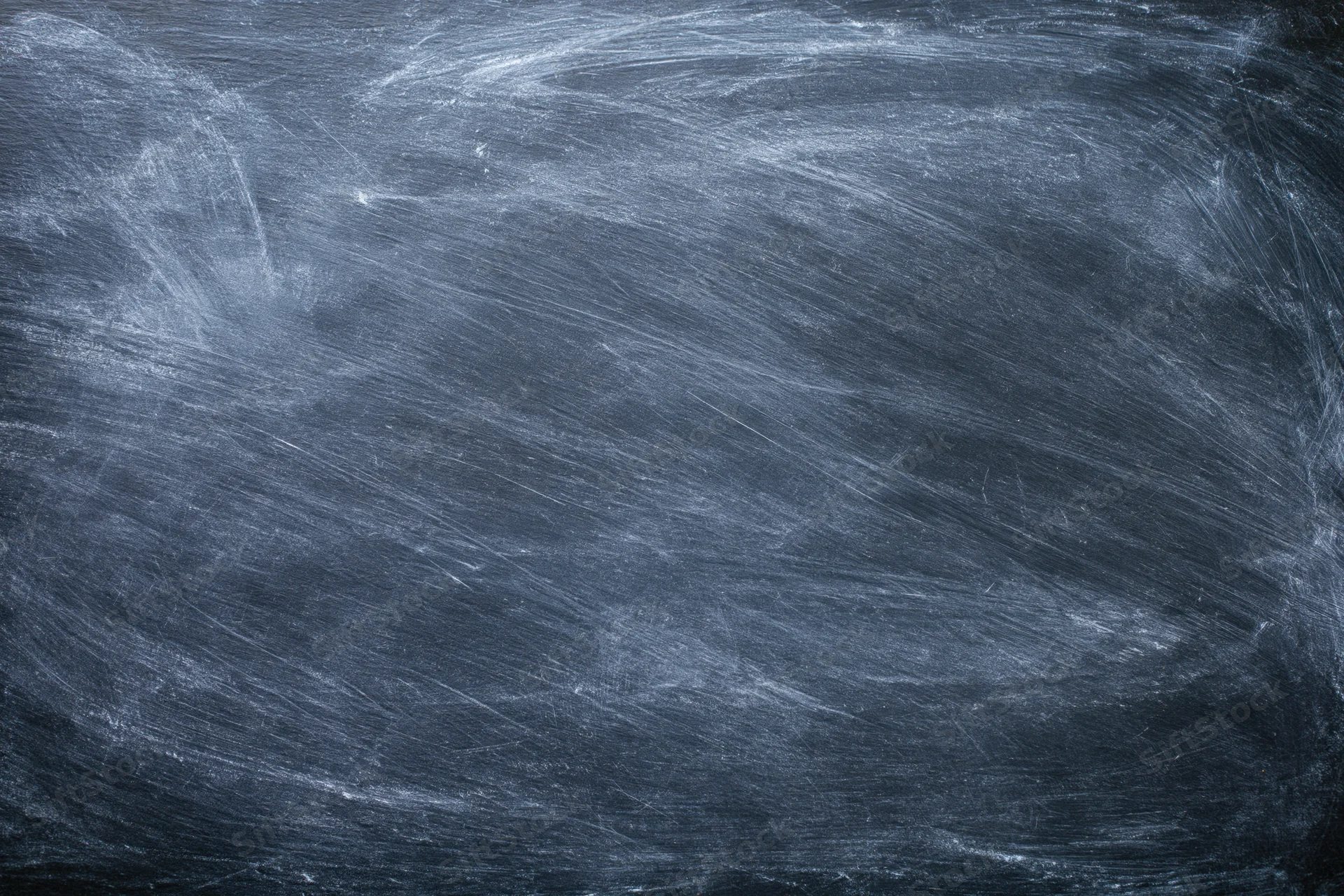 Dark slate chalkboard surface with faint erased chalk marks and smudges