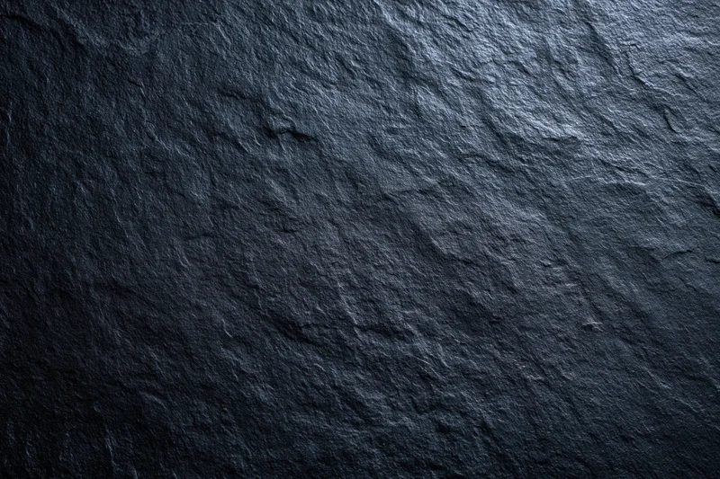 Close-up of dark slate stone surface texture filling the frame