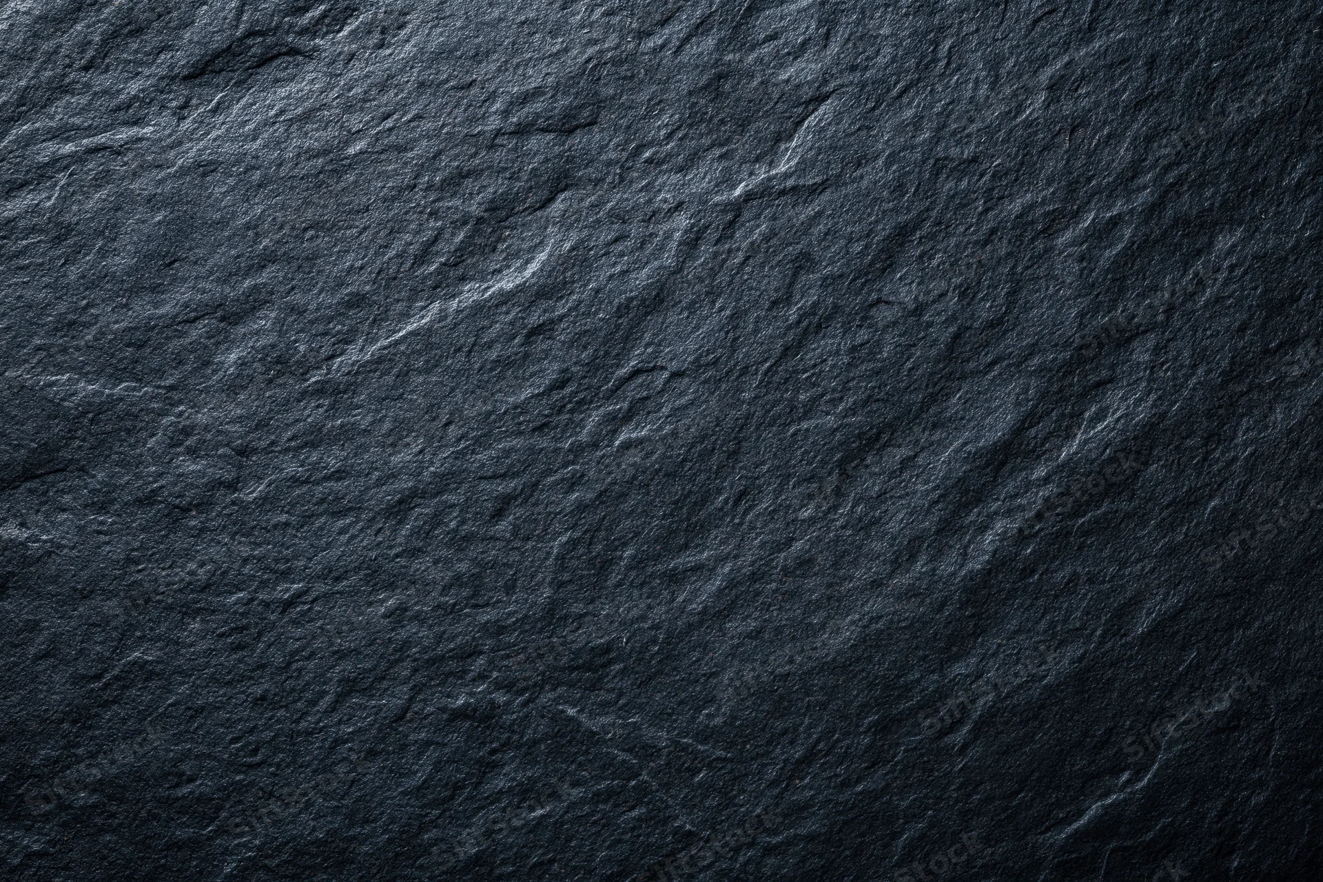 Close-up of dark slate stone surface texture in flat lay view