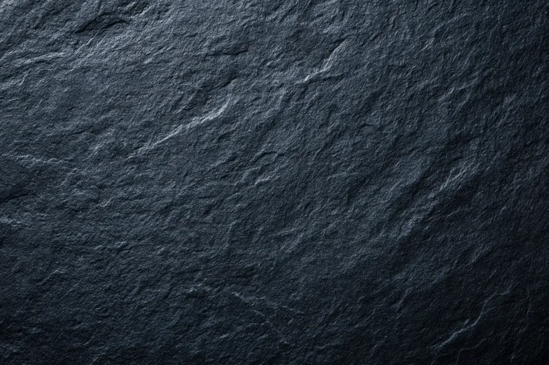Close-up of dark slate stone surface texture in flat lay view