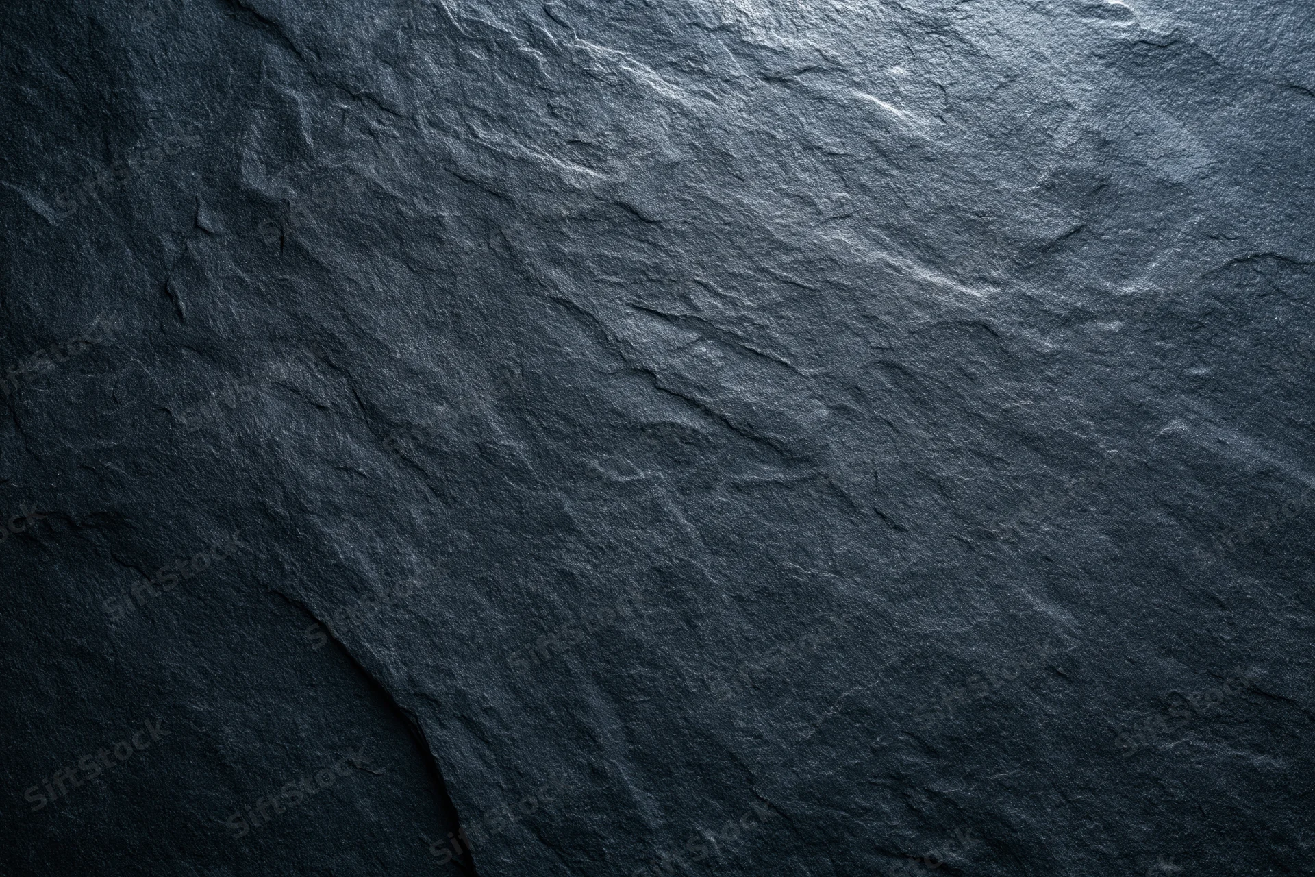 Close-up of dark slate stone surface texture filling the frame