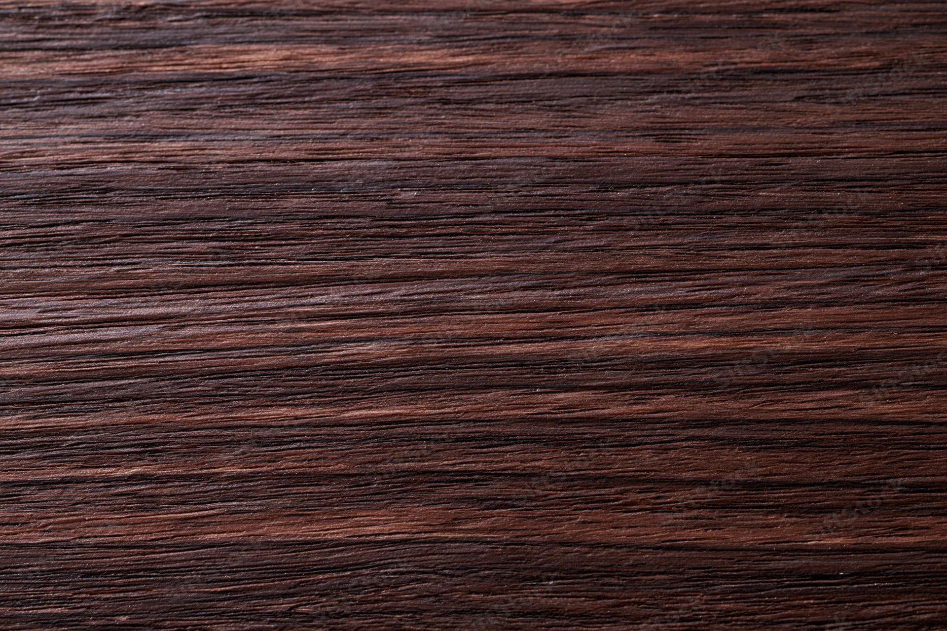 Dark walnut wood surface with visible grain pattern filling the frame