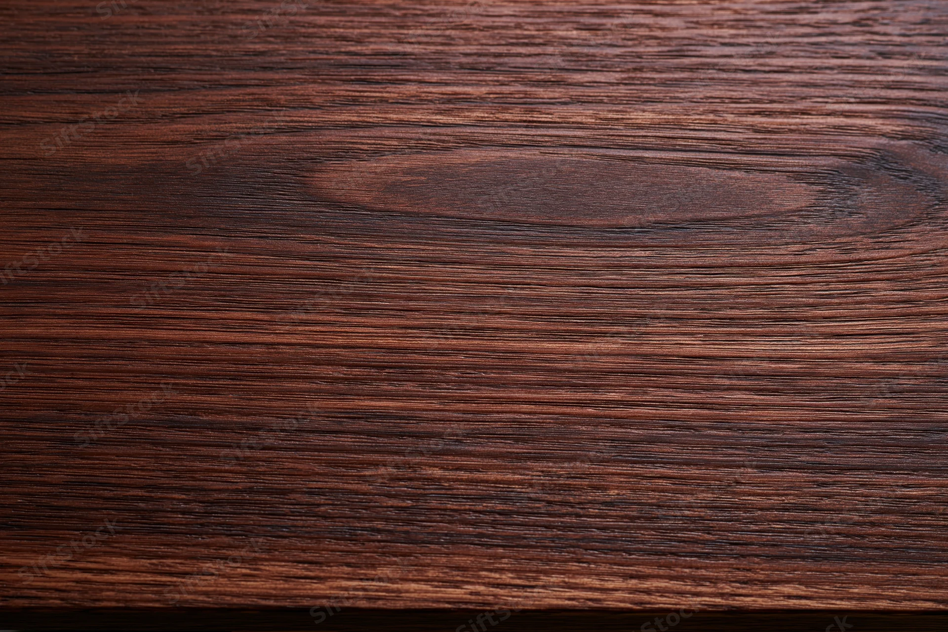 Dark walnut wood surface with visible grain pattern filling the frame