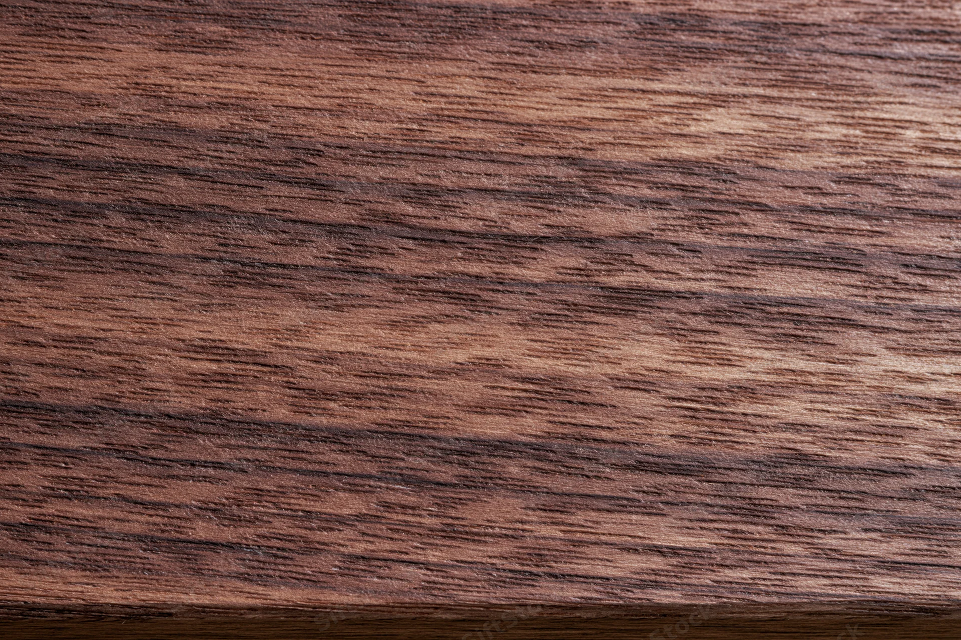 Dark walnut wood surface with visible grain pattern filling the frame