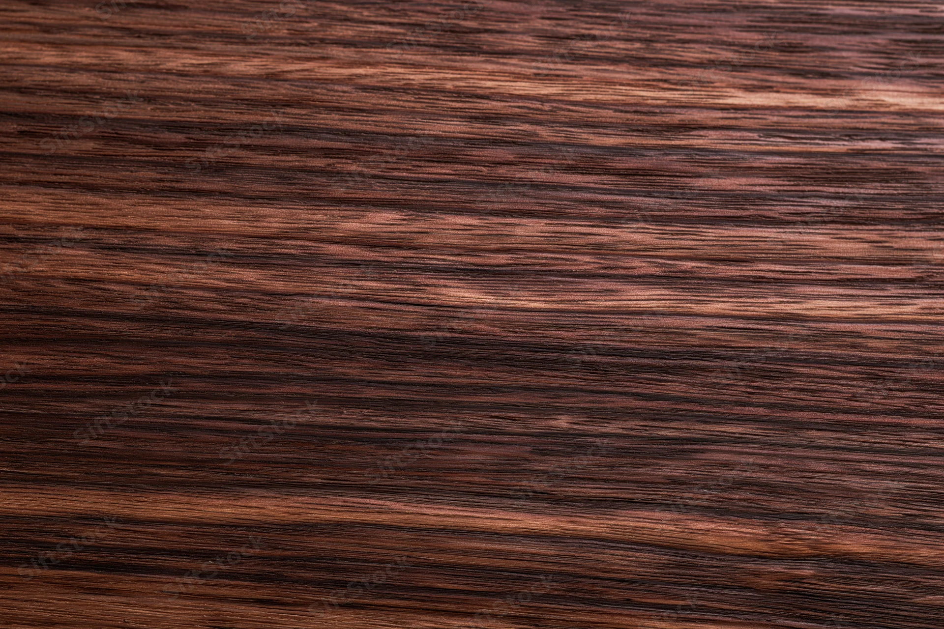 Dark walnut wood surface with visible grain pattern filling the frame