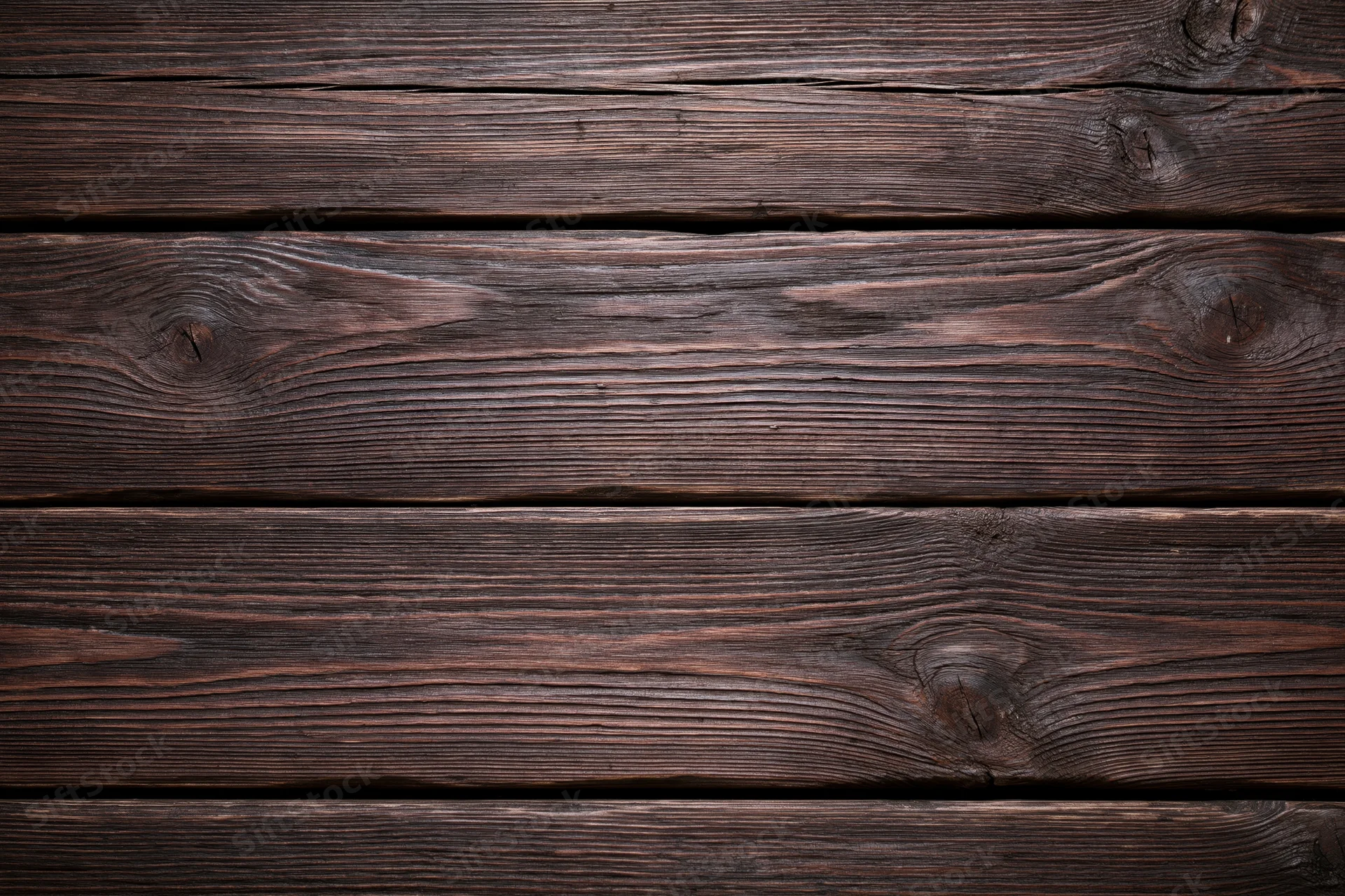 Dark weathered wooden planks arranged horizontally filling the frame