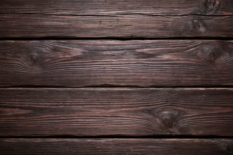 Dark weathered wooden planks arranged horizontally filling the frame