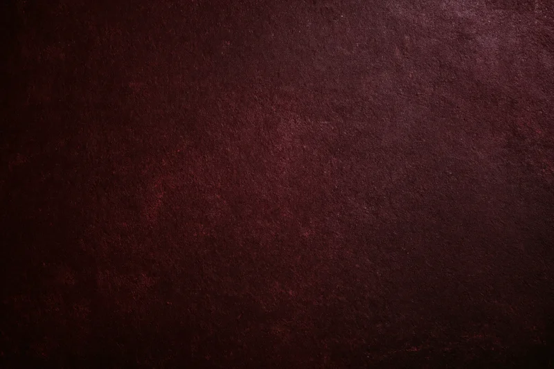 Deep dark maroon textured background with subtle grain and shadow variation