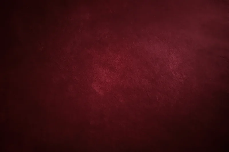 Deep dark maroon textured background with subtle gradient and vintage surface appearance