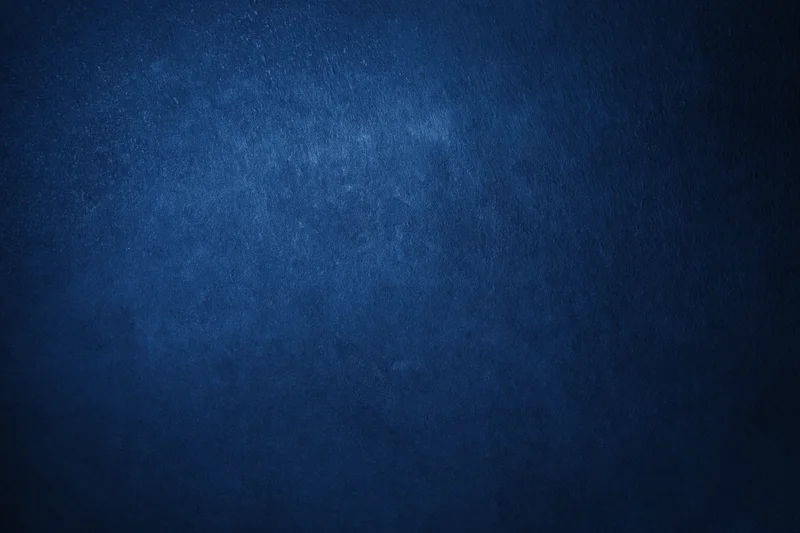 Closeup of deep navy blue textured wall surface filling the frame