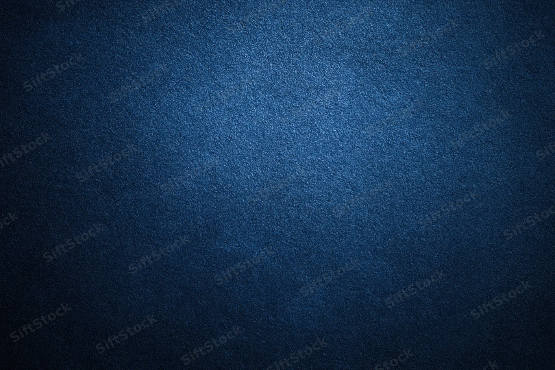Closeup of textured navy blue wall surface filling the frame