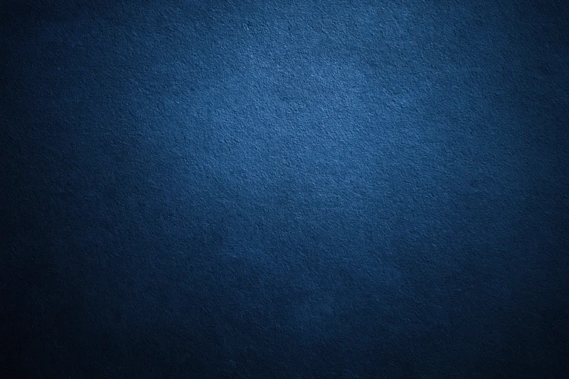 Closeup of textured navy blue wall surface filling the frame