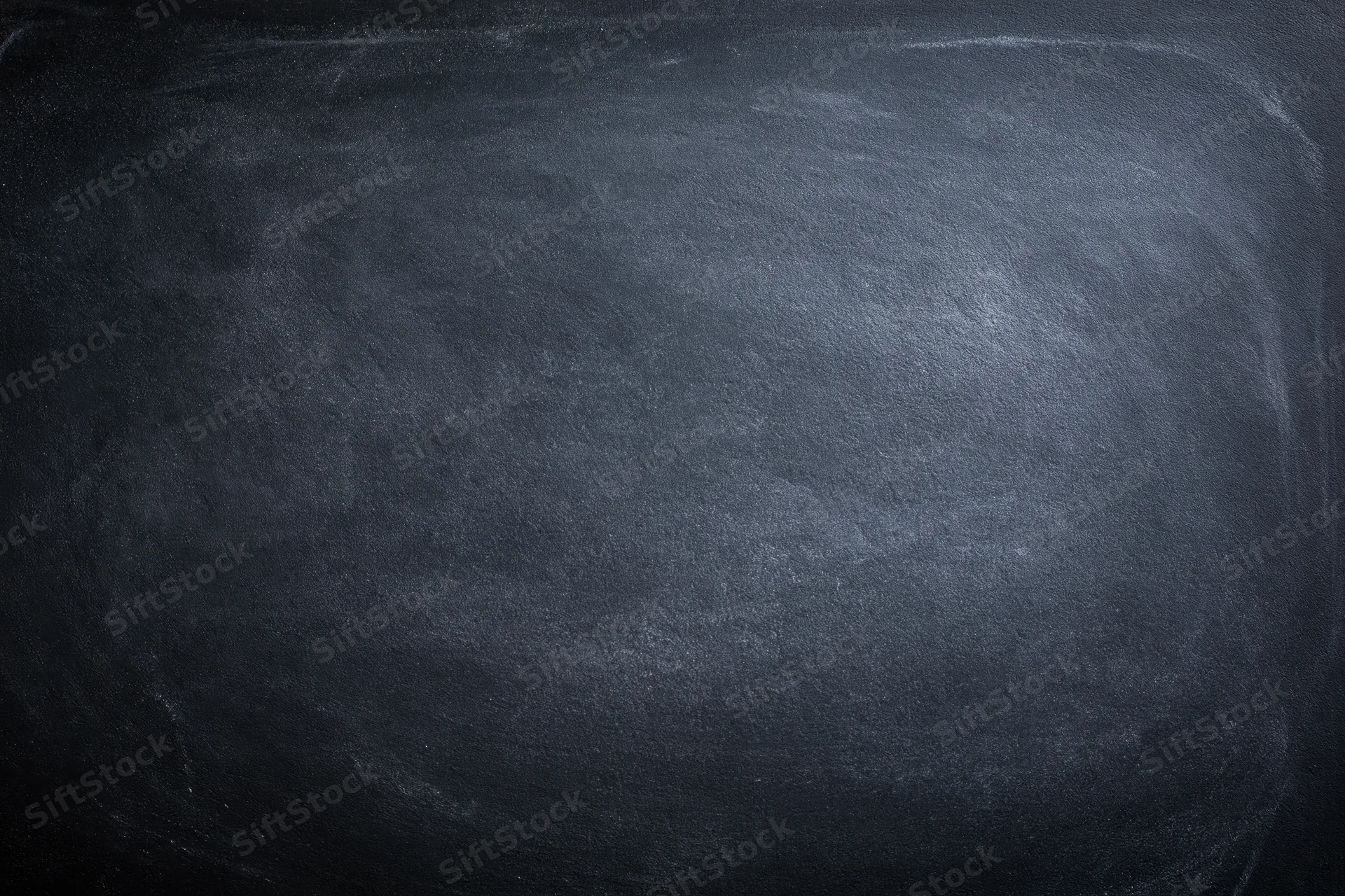 Close-up of an empty blackboard surface with smudged chalk marks filling the frame