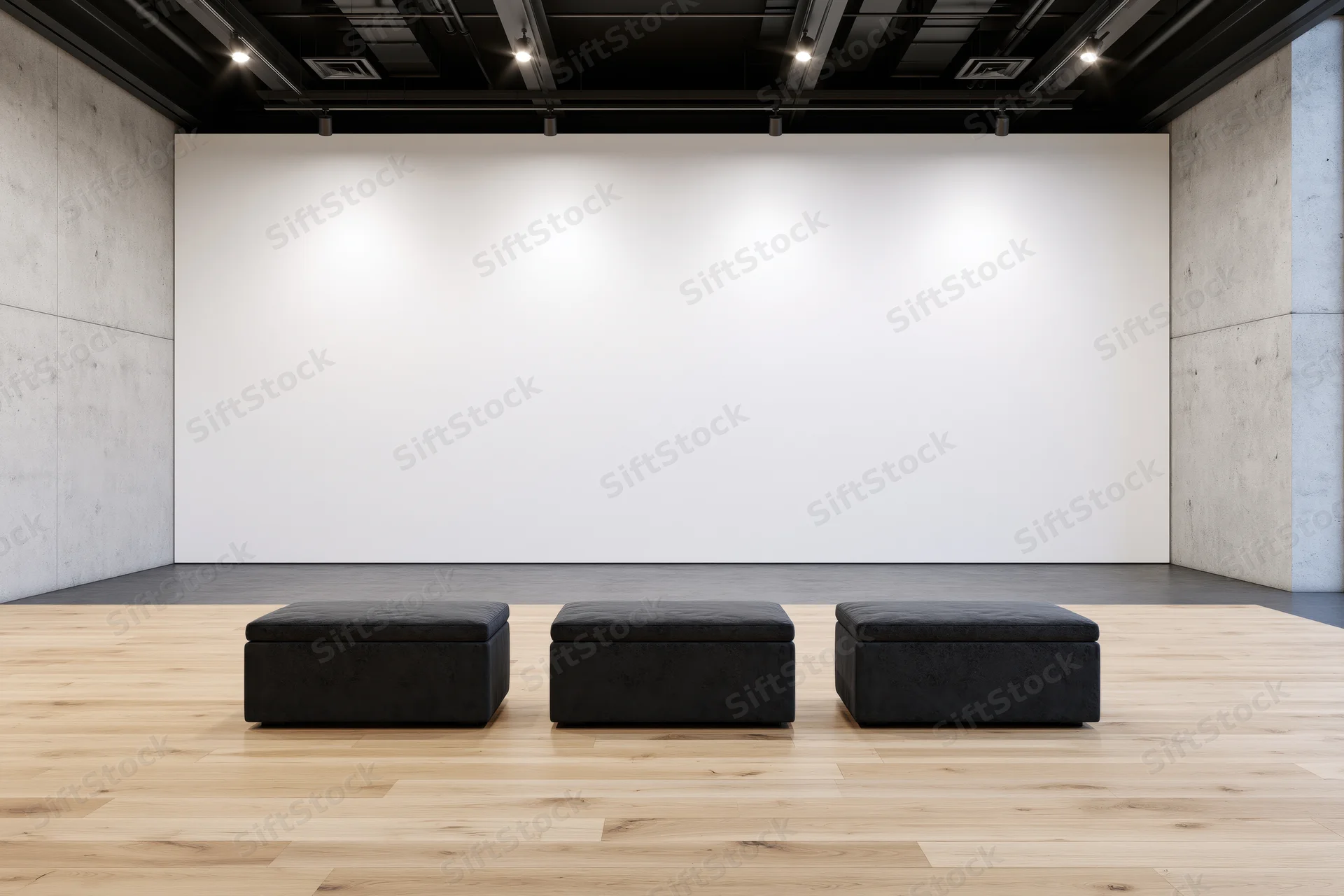 Empty contemporary art gallery interior with three black benches in front of a large white wall