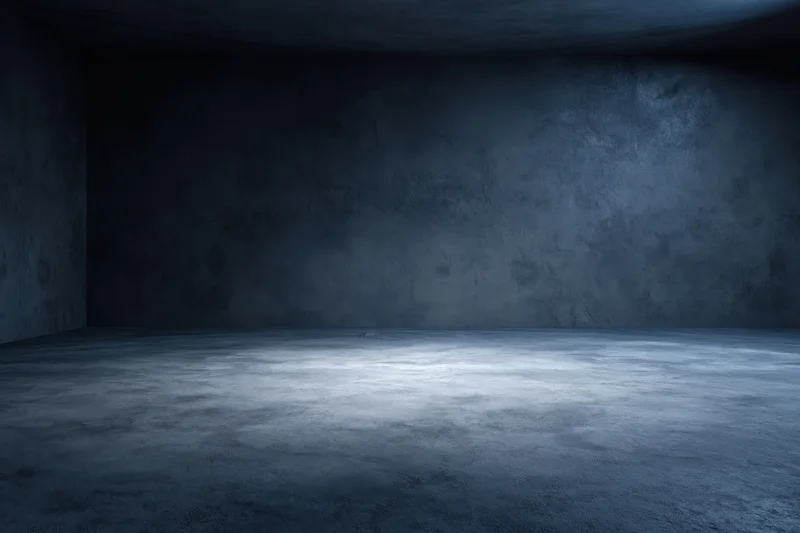 Empty dark concrete room interior with bare walls and floor meeting at corner