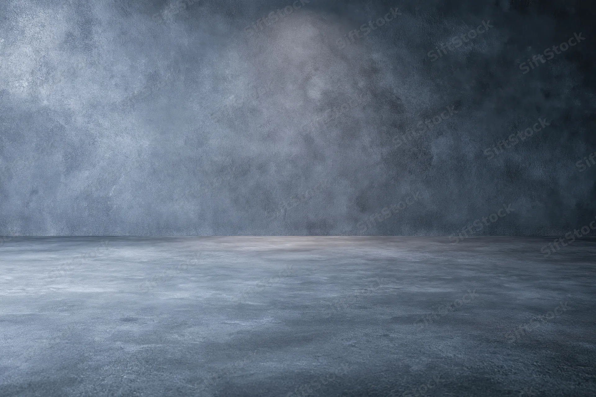 Empty dark grey concrete studio with smooth floor and textured walls