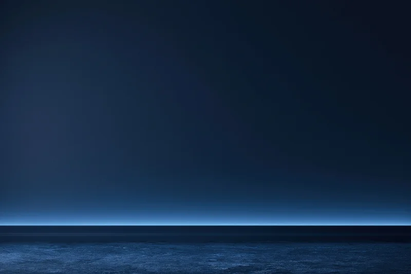 Dark navy blue studio backdrop with flat matte wall and horizon line